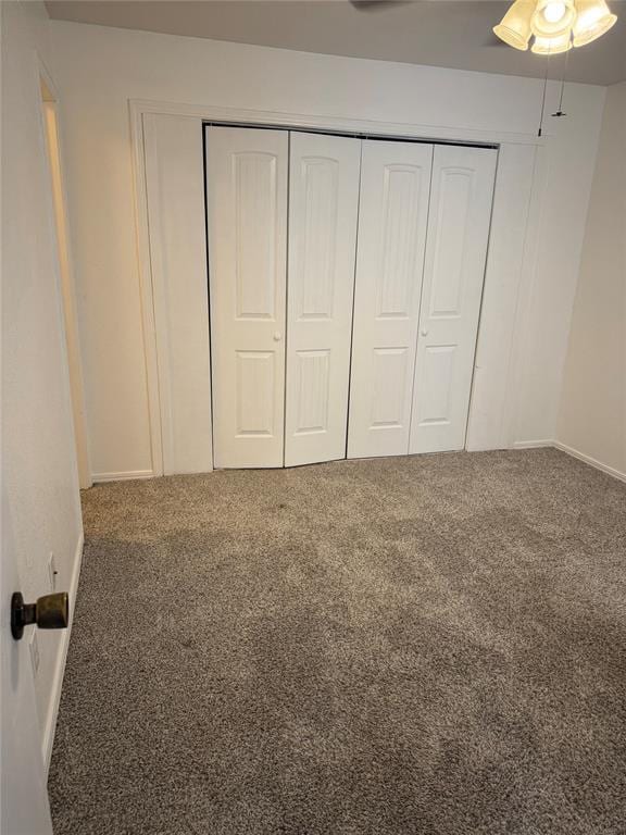 3000 Chautauqua Ave Unit 208, Norman, OK 73072 - unfurnished bedroom featuring carpet floors, a closet, and a ceiling fan
