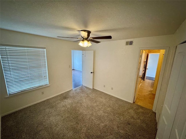 3000 Chautauqua Ave Unit 208, Norman, OK 73072 - carpeted spare room with a textured ceiling and a ceiling fan