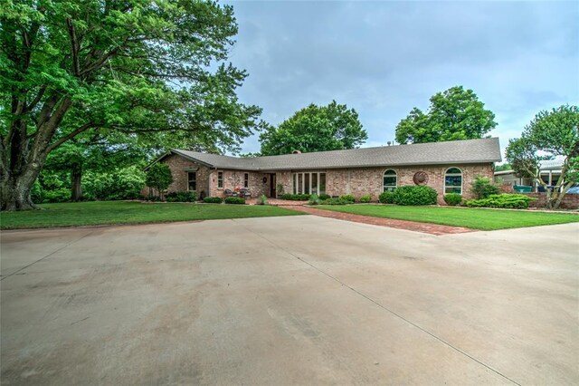 15700 N Western Ave, Edmond, OK 73013 - single story home with brick siding and a front yard