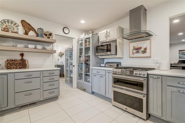 15700 N Western Ave, Edmond, OK 73013 - kitchen with stainless steel appliances, island exhaust hood, gray cabinetry, light countertops, and recessed lighting