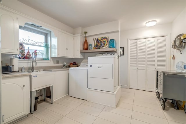 15700 N Western Ave, Edmond, OK 73013 - laundry area with washer and clothes dryer, cabinet space, and light tile patterned flooring