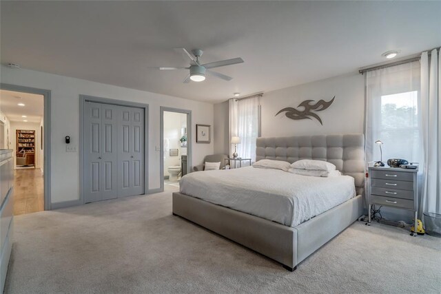 15700 N Western Ave, Edmond, OK 73013 - bedroom with multiple windows, light colored carpet, ensuite bathroom, and ceiling fan