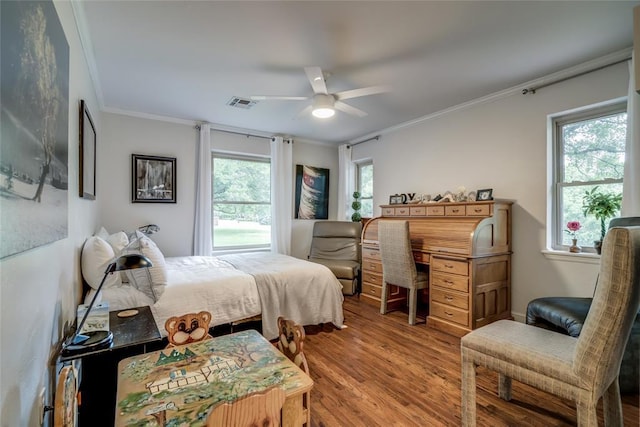 15700 N Western Ave, Edmond, OK 73013 - bedroom featuring wood finished floors, ornamental molding, and a ceiling fan