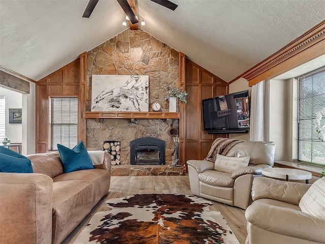 3100 N Eagle Ln, Bethany, OK 73008 - living area with light wood-style flooring, ceiling fan, a fireplace, and a textured ceiling