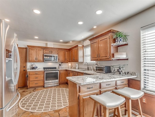 3100 N Eagle Ln, Bethany, OK 73008 - kitchen featuring appliances with stainless steel finishes, a peninsula, open shelves, recessed lighting, and light stone countertops