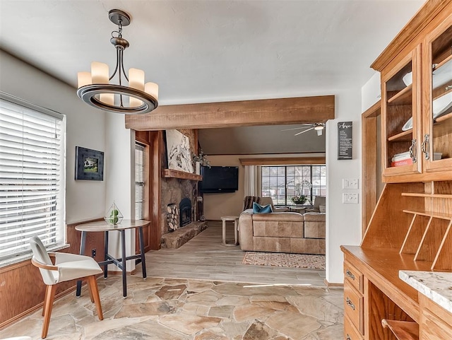 3100 N Eagle Ln, Bethany, OK 73008 - dining area featuring a stone fireplace, a ceiling fan, a chandelier, and light stone finish floors