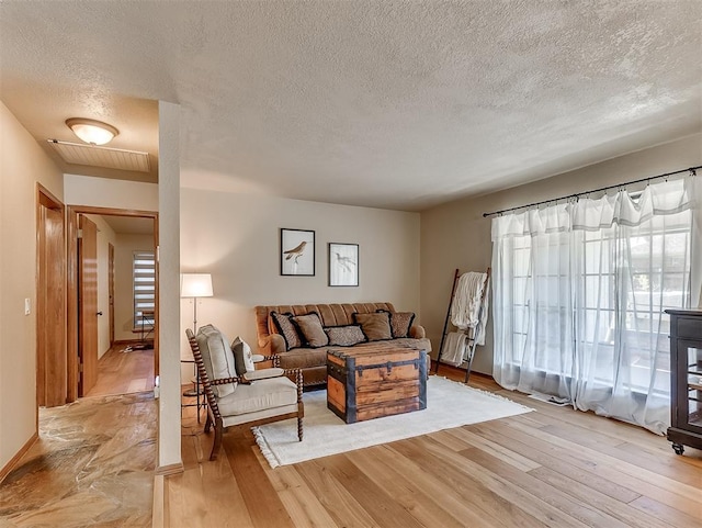 3100 N Eagle Ln, Bethany, OK 73008 - living area with a textured ceiling and light wood-type flooring