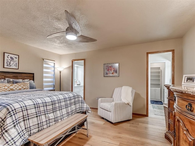 3100 N Eagle Ln, Bethany, OK 73008 - bedroom featuring light wood-style floors, a textured ceiling, ceiling fan, and ensuite bathroom