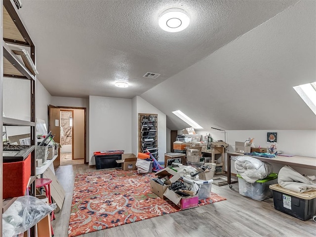 3100 N Eagle Ln, Bethany, OK 73008 - additional living space featuring a textured ceiling, wood finished floors, a skylight, and vaulted ceiling