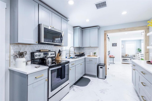 1218 N Brookline Ave, Oklahoma City, OK 73107 - kitchen featuring stainless steel appliances, gray cabinets, light countertops, recessed lighting, and tasteful backsplash