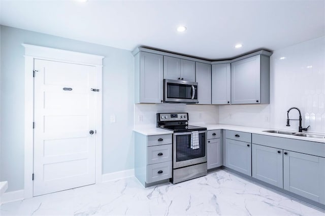1218 N Brookline Ave, Oklahoma City, OK 73107 - kitchen with gray cabinetry, stainless steel appliances, light marble finish flooring, light countertops, and recessed lighting