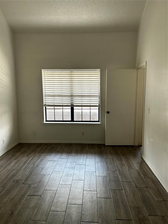 11130 Stratford Dr Unit 418, Oklahoma City, OK 73120 - unfurnished room with dark wood-type flooring and baseboards