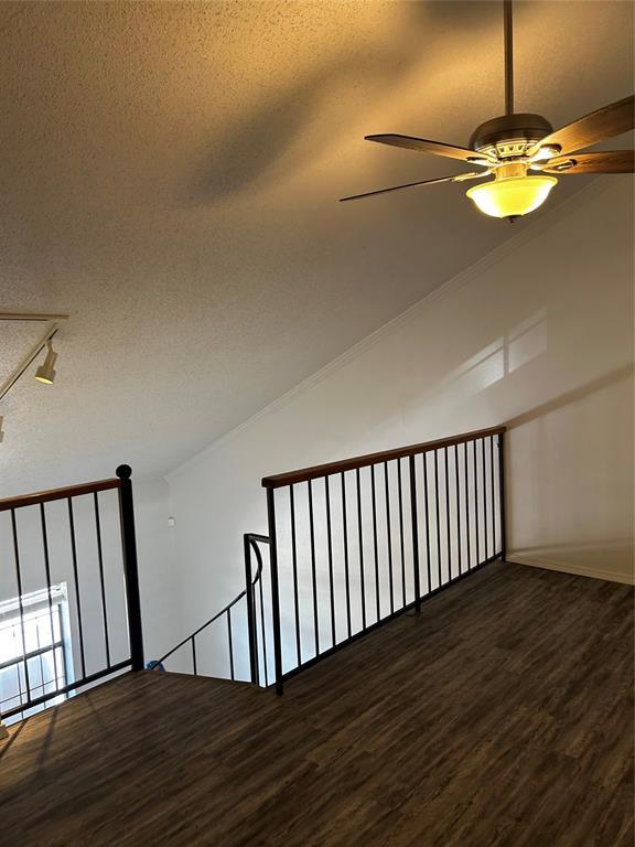 11130 Stratford Dr Unit 418, Oklahoma City, OK 73120 - additional living space featuring wood finished floors, a textured ceiling, ceiling fan, and vaulted ceiling