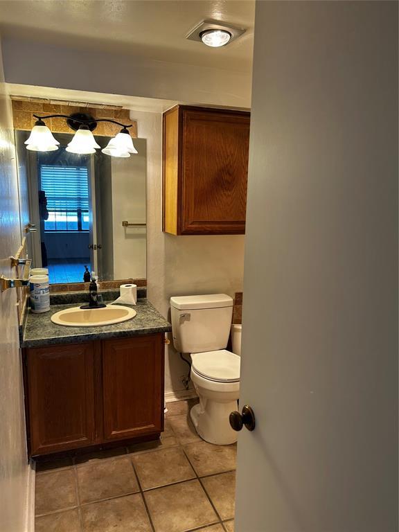11130 Stratford Dr Unit 418, Oklahoma City, OK 73120 - half bathroom with tile patterned floors and vanity