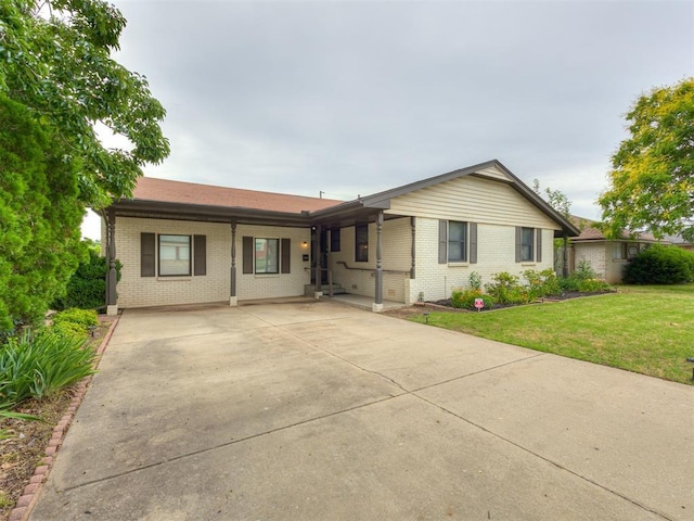 5936 N Ione Dr, Oklahoma City, OK 73122 - single story home featuring brick siding, a front yard, and concrete driveway