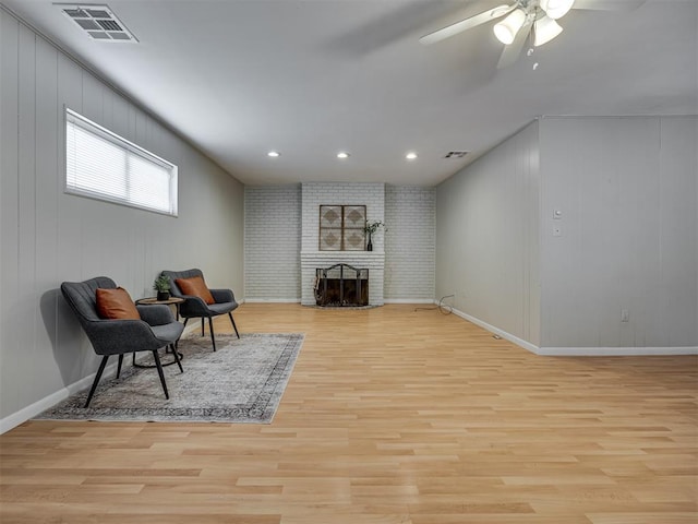 5936 N Ione Dr, Oklahoma City, OK 73122 - living area with light wood-style floors, a ceiling fan, a brick fireplace, and recessed lighting