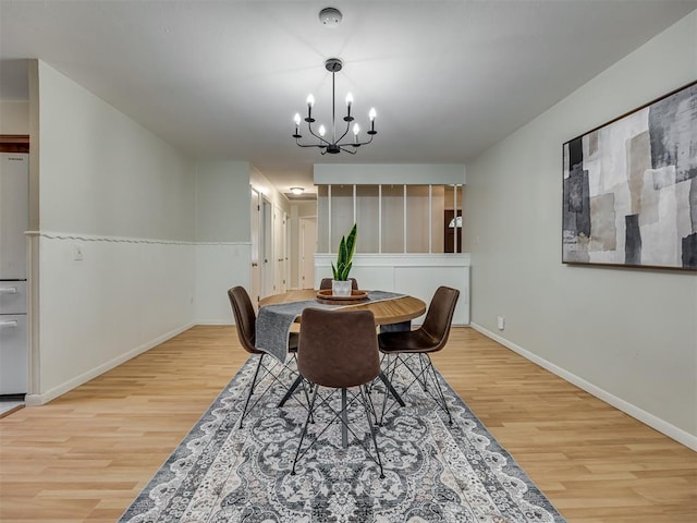 5936 N Ione Dr, Oklahoma City, OK 73122 - dining area featuring wood finished floors and a chandelier