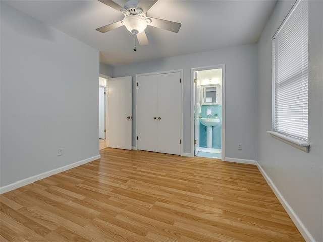 5936 N Ione Dr, Oklahoma City, OK 73122 - unfurnished bedroom featuring light wood-style floors, connected bathroom, ceiling fan, and a closet