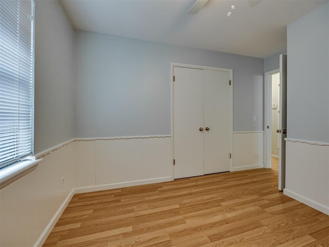 5936 N Ione Dr, Oklahoma City, OK 73122 - unfurnished room with light wood-type flooring, ceiling fan, and a wainscoted wall