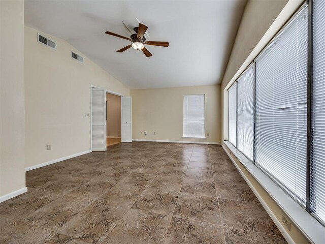 5936 N Ione Dr, Oklahoma City, OK 73122 - unfurnished room with ceiling fan, stone finish floors, and high vaulted ceiling