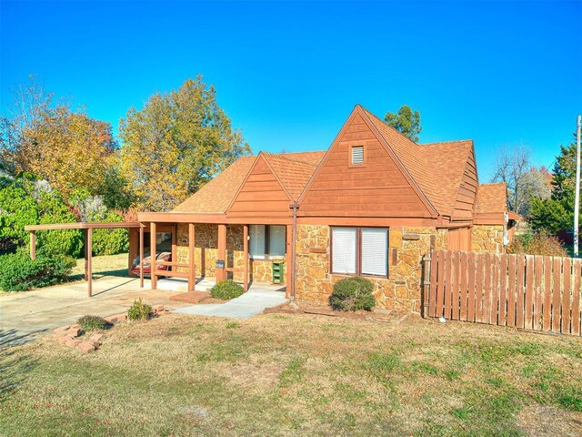 5905 NW 50th St, Oklahoma City, OK 73122 - view of front of property with stone siding, roof with shingles, and a patio