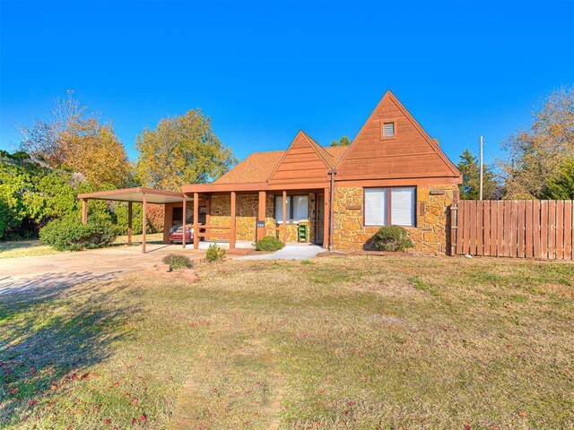 5905 NW 50th St, Oklahoma City, OK 73122 - view of front of property featuring concrete driveway, stone siding, an attached carport, and covered porch
