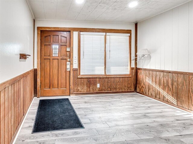 5905 NW 50th St, Oklahoma City, OK 73122 - entryway with light wood finished floors, wooden walls, ornamental molding, and a wainscoted wall