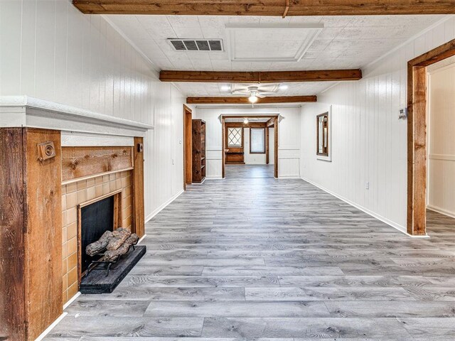 5905 NW 50th St, Oklahoma City, OK 73122 - unfurnished living room featuring wood finished floors, beamed ceiling, a fireplace, and wooden walls