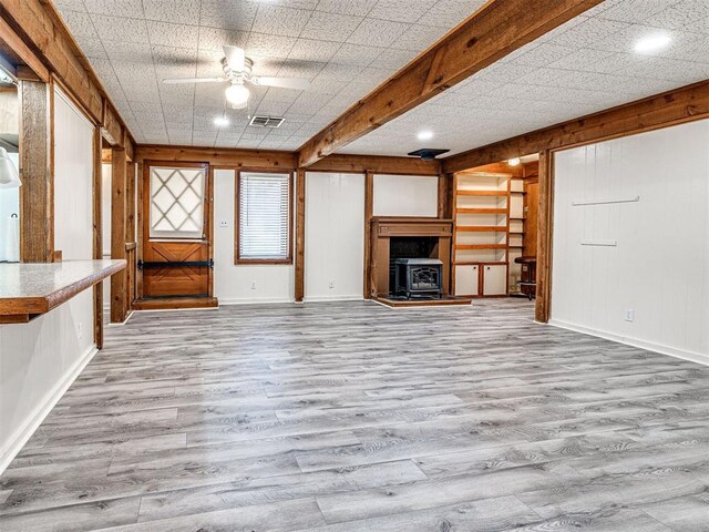 5905 NW 50th St, Oklahoma City, OK 73122 - unfurnished living room featuring wood finished floors, ceiling fan, and a wood stove