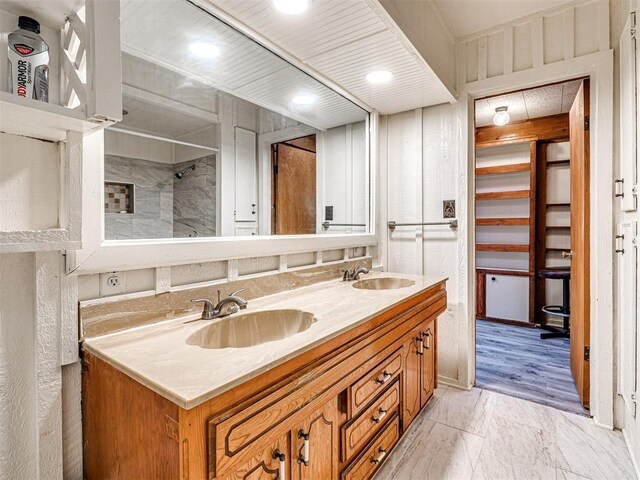5905 NW 50th St, Oklahoma City, OK 73122 - full bath with double vanity, a shower, and marble look tiles