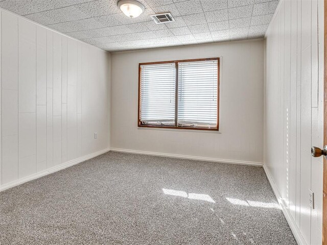 5905 NW 50th St, Oklahoma City, OK 73122 - carpeted spare room with wood walls