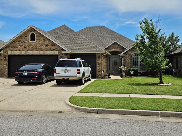 3212 San Juan Trl, Moore, OK 73160 - view of front of house featuring a garage, brick siding, concrete driveway, a front yard, and roof with shingles