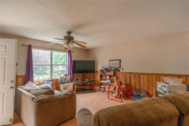 17856 Beechnut Ln, Alex, OK 73003 - living area featuring a ceiling fan, light wood finished floors, wainscoting, and wooden walls