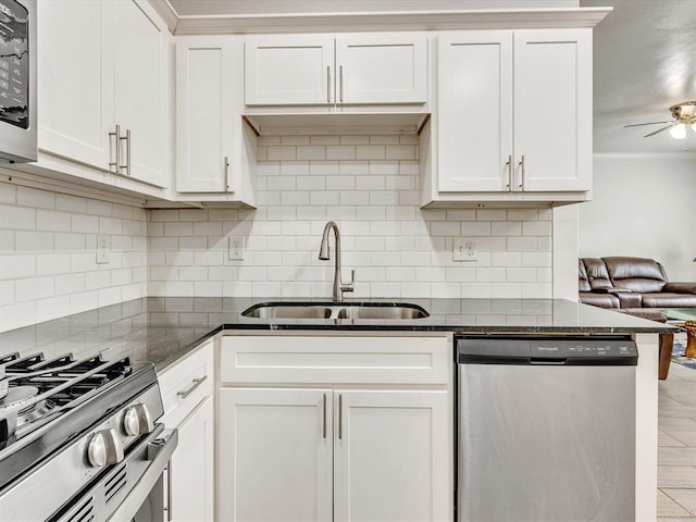 837 SE 68th St, Oklahoma City, OK 73149 - kitchen featuring appliances with stainless steel finishes, crown molding, a ceiling fan, tasteful backsplash, and dark stone counters