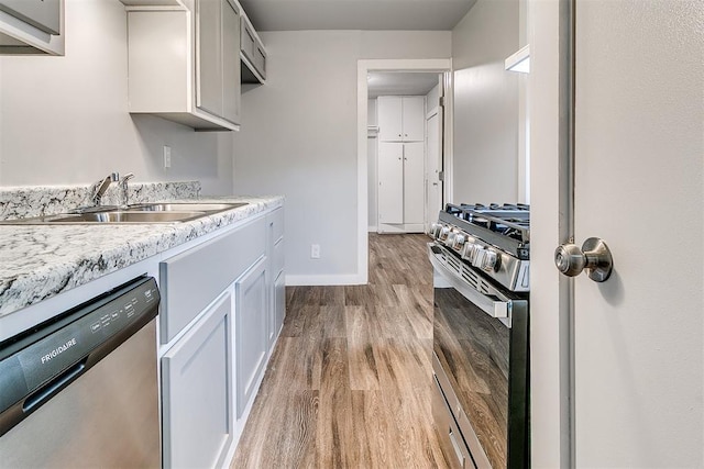 1617 SW 31st St, Oklahoma City, OK 73119 - kitchen featuring appliances with stainless steel finishes, wood finished floors, and light countertops
