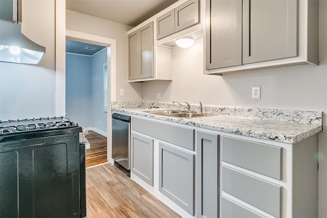 1617 SW 31st St, Oklahoma City, OK 73119 - kitchen with range with gas cooktop, exhaust hood, light wood-type flooring, gray cabinetry, and dishwasher