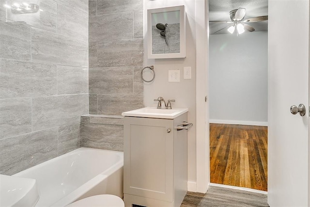1617 SW 31st St, Oklahoma City, OK 73119 - bathroom with vanity, wood finished floors, a bath, and ceiling fan