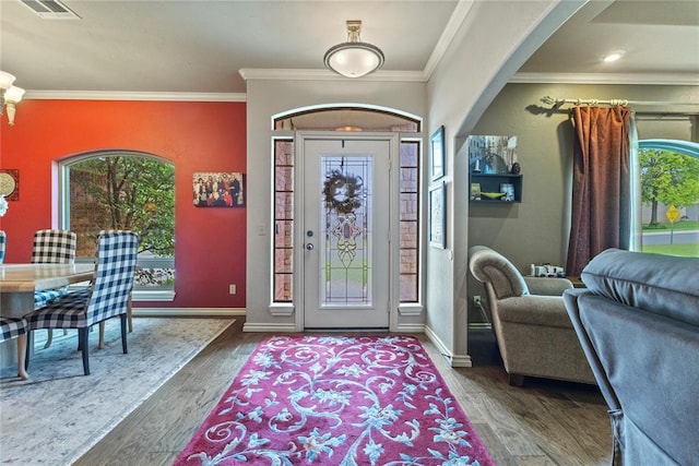 1414 Chisholm Trl, Weatherford, OK 73096 - entrance foyer featuring wood finished floors, crown molding, and arched walkways