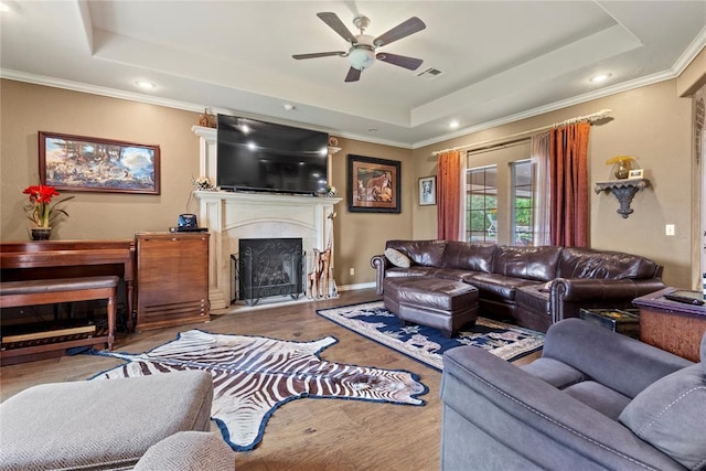 1414 Chisholm Trl, Weatherford, OK 73096 - living area with a raised ceiling, a ceiling fan, a fireplace with raised hearth, recessed lighting, and ornamental molding