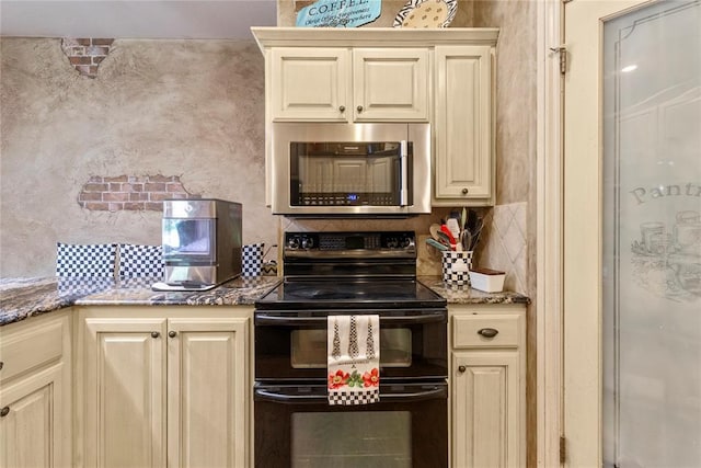 1414 Chisholm Trl, Weatherford, OK 73096 - kitchen with black / electric stove, stainless steel microwave, tasteful backsplash, and stone countertops