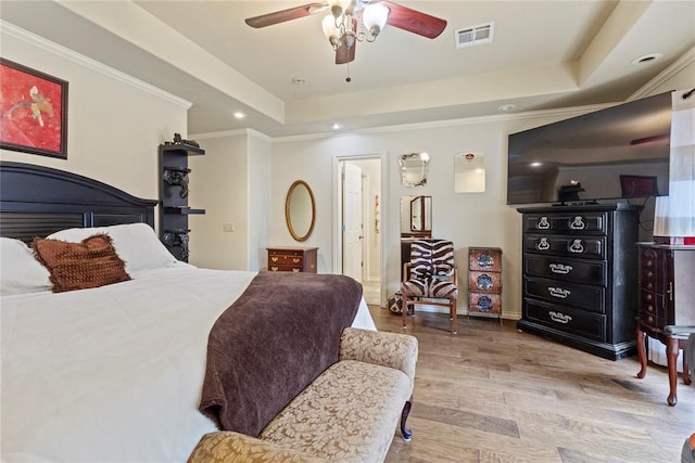1414 Chisholm Trl, Weatherford, OK 73096 - bedroom featuring wood finished floors, a tray ceiling, recessed lighting, ornamental molding, and ceiling fan