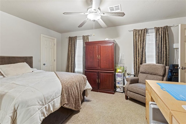 1414 Chisholm Trl, Weatherford, OK 73096 - bedroom featuring multiple windows, light colored carpet, and ceiling fan