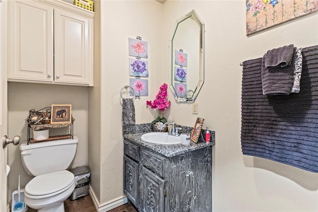 1414 Chisholm Trl, Weatherford, OK 73096 - half bathroom featuring vanity and wood finished floors