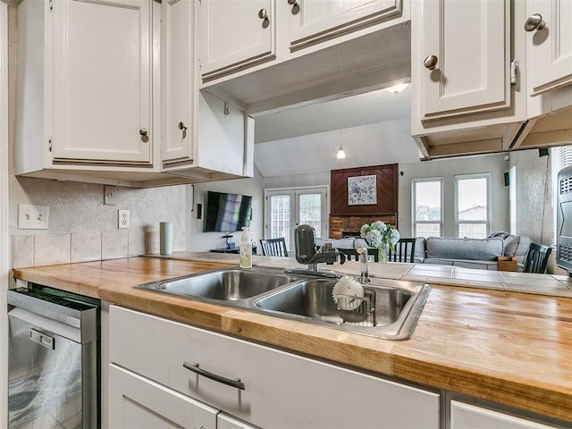 401 NW 120th St, Oklahoma City, OK 73114 - kitchen with wood counters, stainless steel dishwasher, and white cabinetry