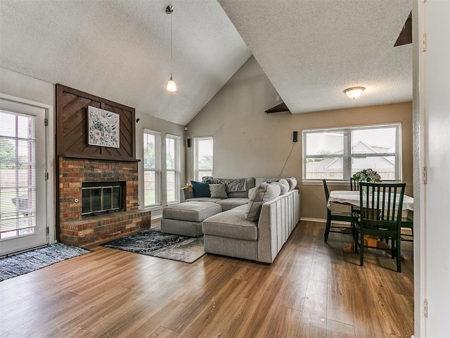 401 NW 120th St, Oklahoma City, OK 73114 - living area with a textured ceiling, wood finished floors, a fireplace, and high vaulted ceiling