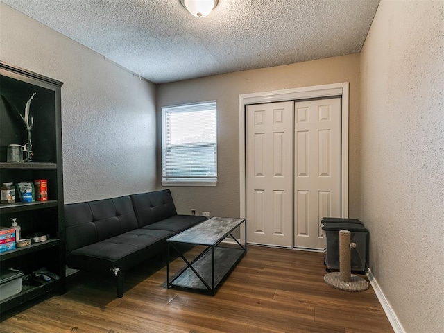 401 NW 120th St, Oklahoma City, OK 73114 - living room featuring a textured wall, wood finished floors, and a textured ceiling