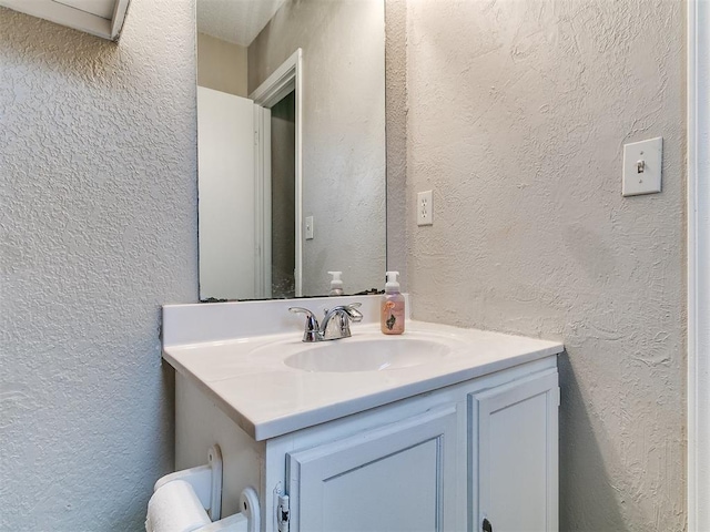 401 NW 120th St, Oklahoma City, OK 73114 - bathroom featuring a textured wall and vanity