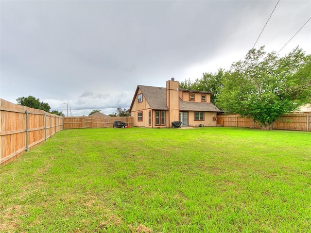401 NW 120th St, Oklahoma City, OK 73114 - back of house featuring a fenced backyard, a chimney, and a shingled roof