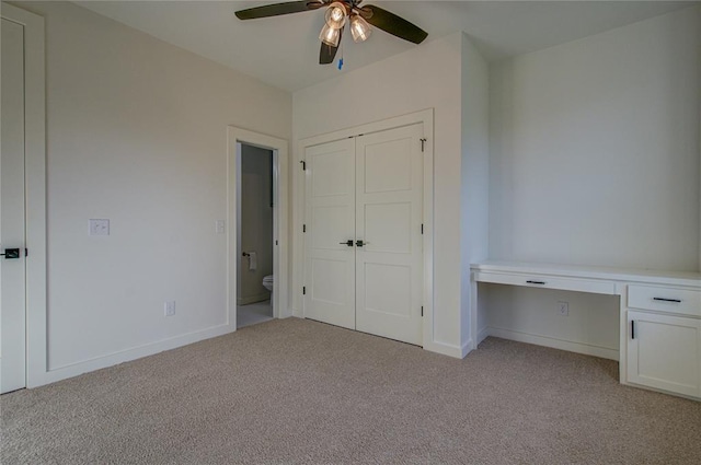 2006 Ithaca Dr, Norman, OK 73071 - unfurnished bedroom with light carpet, built in study area, a closet, and ceiling fan
