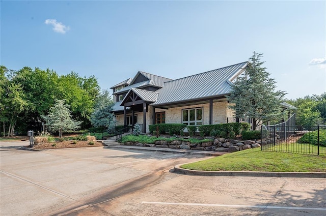 2006 Ithaca Dr, Norman, OK 73071 - view of front facade featuring stone siding, a standing seam roof, and a metal roof